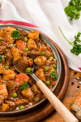 Beef Curry Stew with Potatoes and Carrots on Wooden Background. Selective focus.