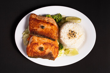 dish with grilled salmon rice and vegetables