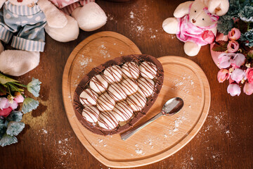 brazilian easter egg with creamy spoon stuffed with milk nest flavor with nutella on a heart-shaped...