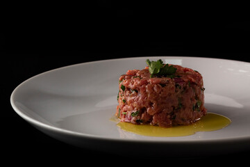Steak Tartare with oil in white dish