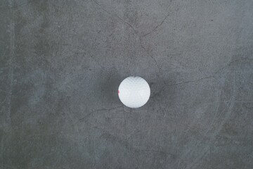 White golf ball isolated on grey background 