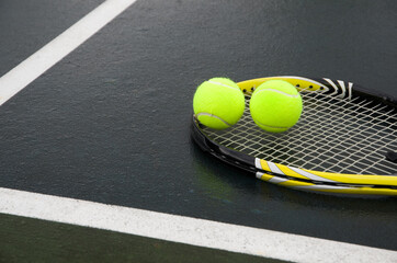 Yellow Tennis Racket with Balls on a Court