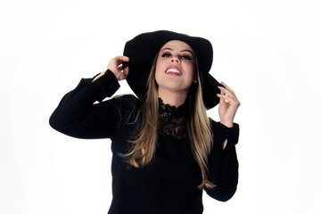 blonde woman wearing black outfit on white background with hat