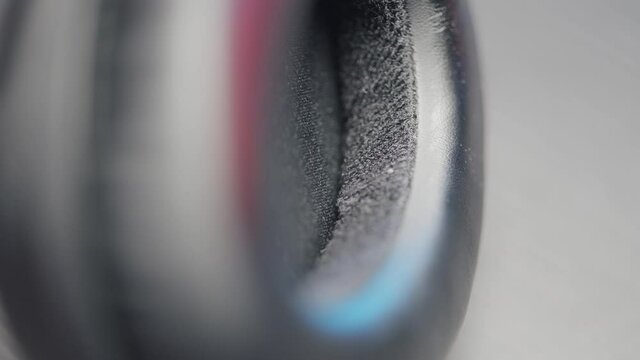 Extreme close up of noise canceling wireless headphones on blurred background. Action. Concept of music and electronic devices.