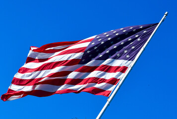 US flag blowing proudly on America Holiday Independence Day