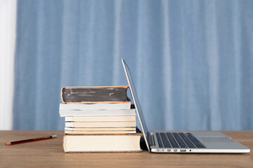 Laptop and stack of books