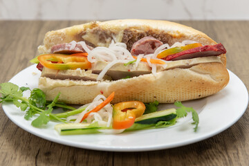 Hearty Vietnam cuisine sandwich overloaded with meat and vegetables on a plate for a complete meal
