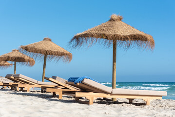 Deck chairs and straw umbrellas on the wonderful island of Formentera in Spain