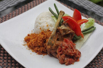Delicious Homemade Indonesian Duck Salad served with Hot Rice, Fresh Vegetables, and Cooked Chili Sauce