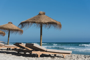 Deck chairs and straw umbrellas on the wonderful island of Formentera in Spain