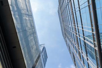 Chengdu cityscape low angle view of modern office building with clouds blue sky
