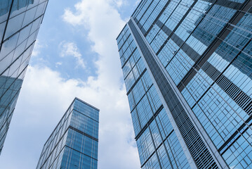 Chengdu cityscape low angle view of modern office building with clouds blue sky
