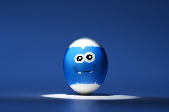 Blue festive easter egg with emoticon