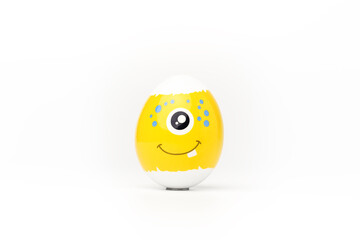 Yellow festive easter egg with one-eyed emoticon