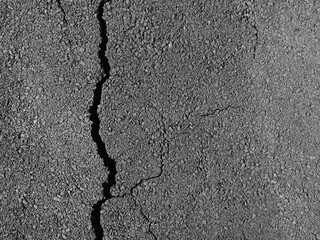 Obraz premium Old worn and cracked asphalt with cracks