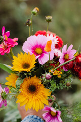 Bouquet of wildflowers held in a hand on a farm