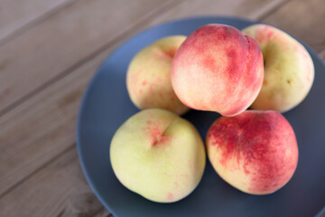 Fresh big peaches on the plate