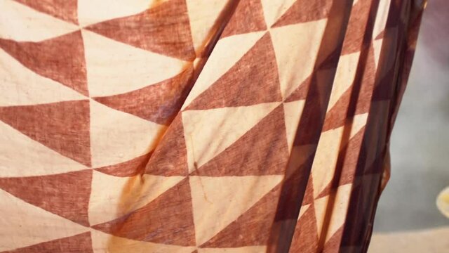 Closeup Shot Of Wet Organic Textiles During Dyeing Process With Red Madder Dye