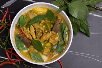 Green curry chicken on black background