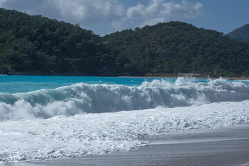 Blue waves roll onto the sandy shore