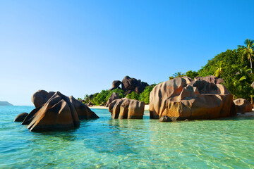 Beatiful beach Anse Source d'Argent with big granite rocks in sunny day. La Digue Island, Seychelles.