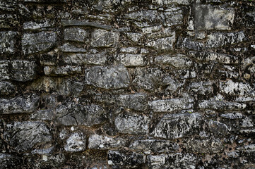 Texture of a stone wall. Old castle stone wall texture background. Stone wall as a background or texture. An example of masonry as a cladding of external walls.