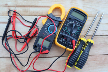 Digital multimeter, clamp-on meter with probes, electrical measuring instruments, and screwdrivers...