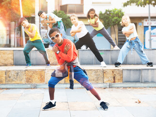 Modern tweens dancing on summer street. Urban lifestyle. Hip-hop generation