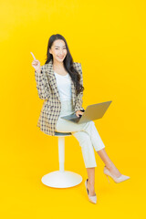 Portrait beautiful young asian woman smile with computer laptop