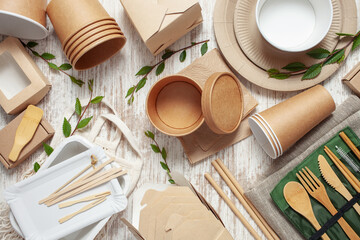 Eco craft paper tableware. Paper cups, dishes, bag, fast food containers and wooden cutlery on pink...