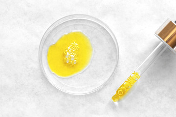 Obraz na płótnie Canvas Liquid yellow retinol cosmetic serum