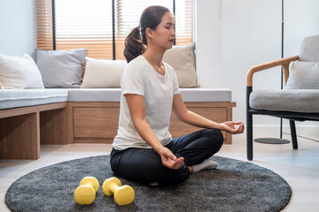 a lively girl meditating to keep calm mind and being relaxed as her indoor leisure