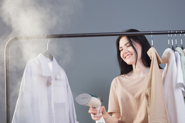 young brunette girl with steamer and clothes
