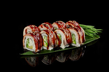 Sushi rolls with eel, cream cheese, avocado and cucumbers