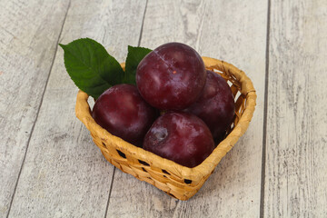 Plum heap in the wooden basket