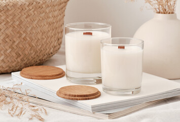 Handmade scented candles in a glass with a wooden lid. Soy wax candles with a wooden wick. Front view.