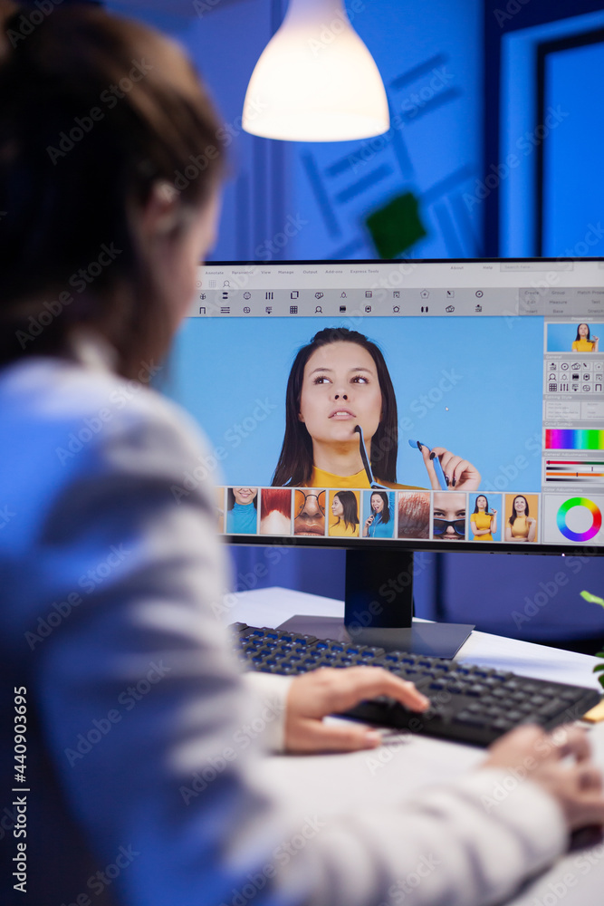Poster creative creator doing portrait retouch using color grade late at night in professional editing offi