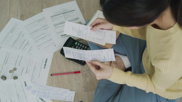 Debt concept. woman is recheck payment date and writing the appointment date on the calendar. Women are having debt and financial problems due to mismanagement of money.