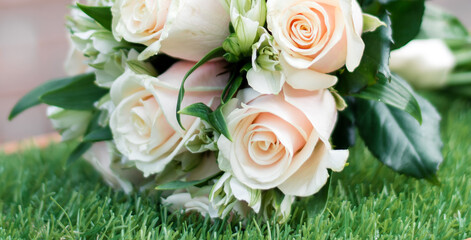 wedding bouquet lying on green grass, white and green flower in a bouquet, close-up of flowers
