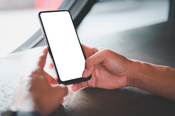 Close up hand using smartphone show white screen for your web site design, logo, app with blurred background.