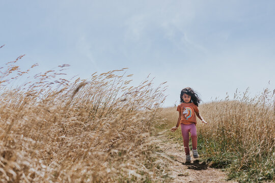 Little Girl Walking On A Coastal Path