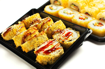 sushi set in an open black plastic bag with two chopsticks. White background