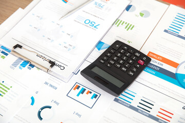 Calculator and pen on financial documents