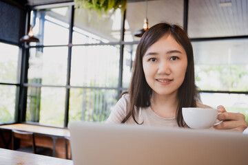 Happy beautiful Asian young woman portrait in the coffee shop.