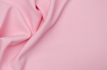 Smooth elegant pink tissue abstract background. Textile background. Cloth wallpaper. Graphics design element