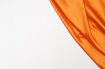 Smooth elegant orange tissue abstract background. Textile background. Cloth wallpaper. Graphics design element