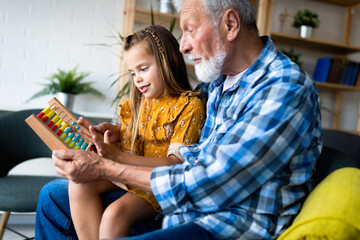 Grandfather and child playing together at home. Happiness, family, relathionship, learning concept.