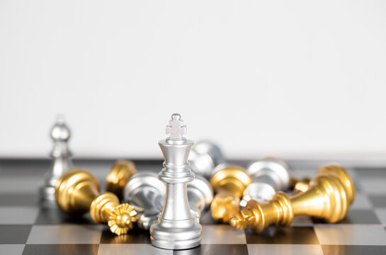 The silver king chess surrounded by chess pieces , business strategy