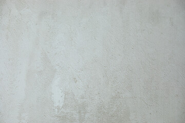 Photo of bright light white gray grunge stone concrete or cement plaster facade wall texture background