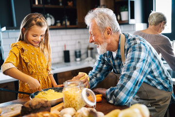 Grandfather and his grandchildren spendig happy fun time in kitchen